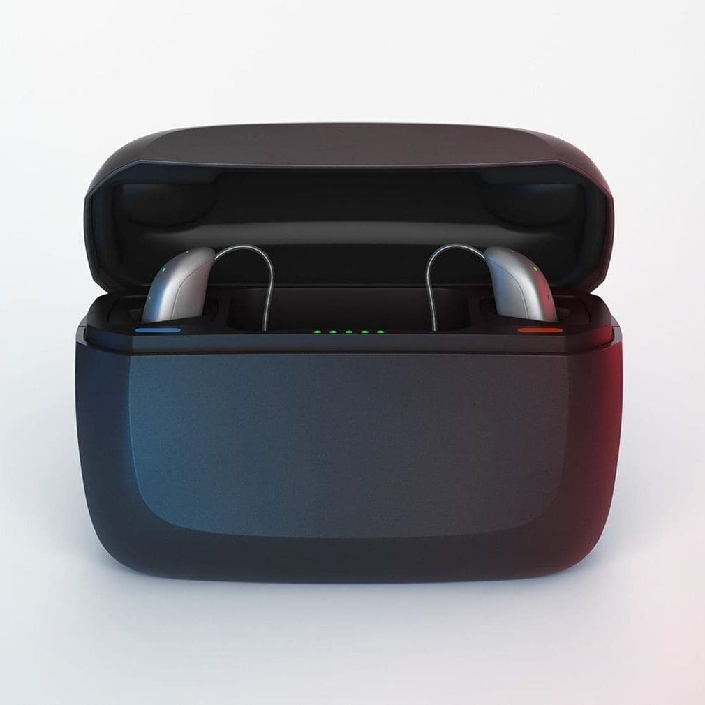 A pair of hearing aids in charging case