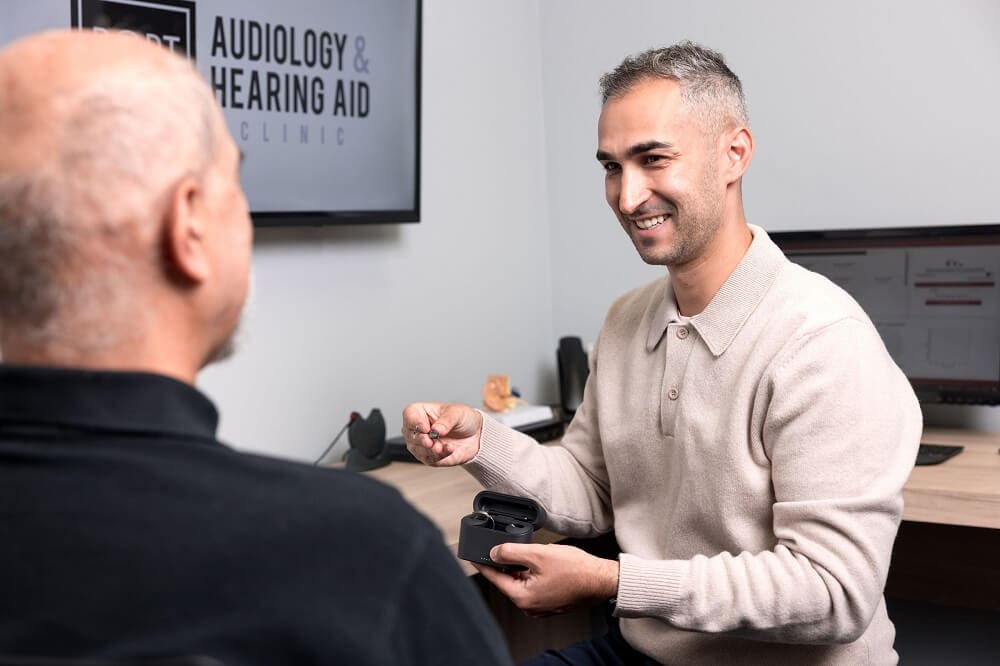 Dario Coletta, M.Sc., Au.D., Reg. CASLPO, Doctor of Audiology with elder patient at Port Credit Audiology & Hearing Aid Clinic